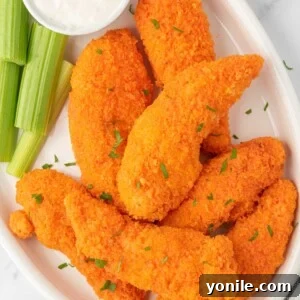 Oven-Crisped Buffalo Tenders 10 A plate of buffalo chicken fingers with celery and dip.