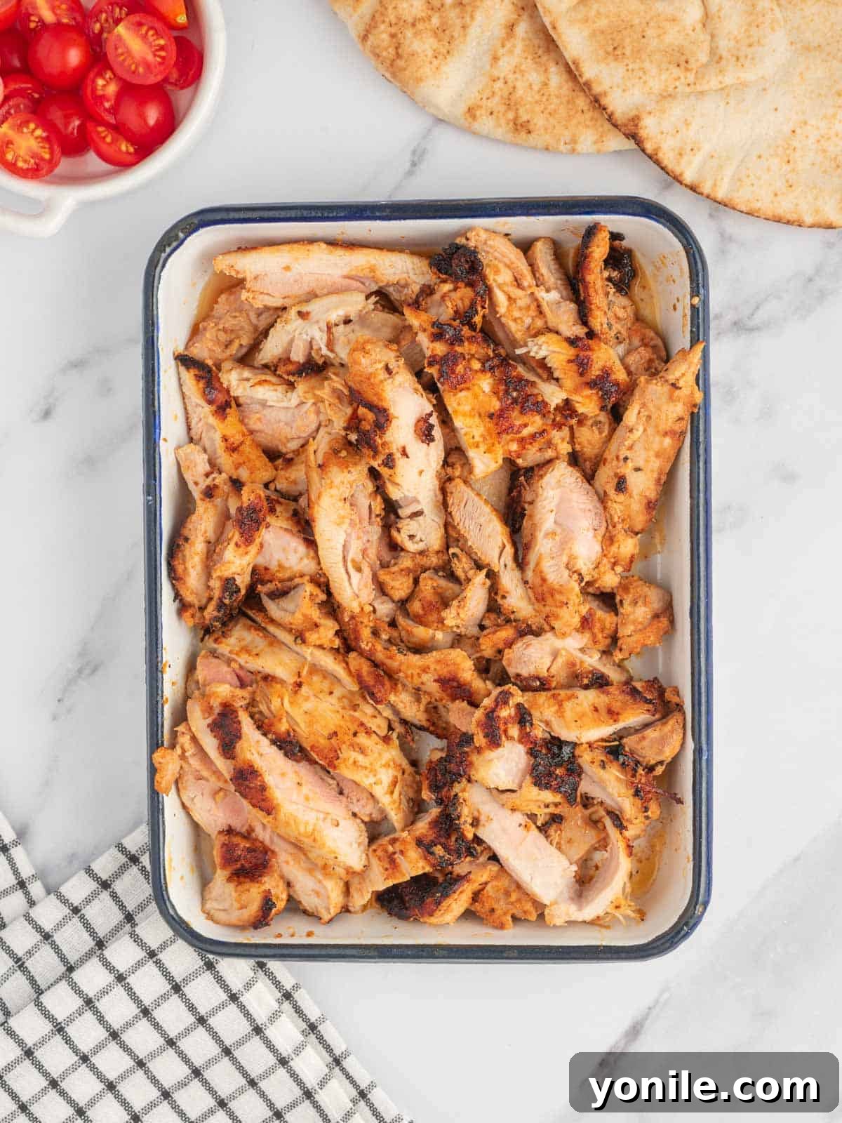 Authentic Homemade Greek Chicken Gyros 5 Cooked and sliced marinated chicken, fresh from the grill, ready to be assembled into homemade Greek chicken gyros.