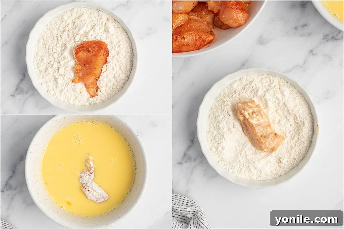 Seasoned chicken being dredged in flour and then egg mixture, showing the coating process.
