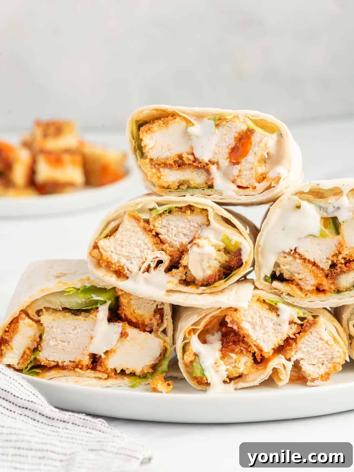 A platter of spicy chicken wrap sandwiches.