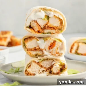 Buffallo chicken tortilla easy lunch wrap on a white plate.