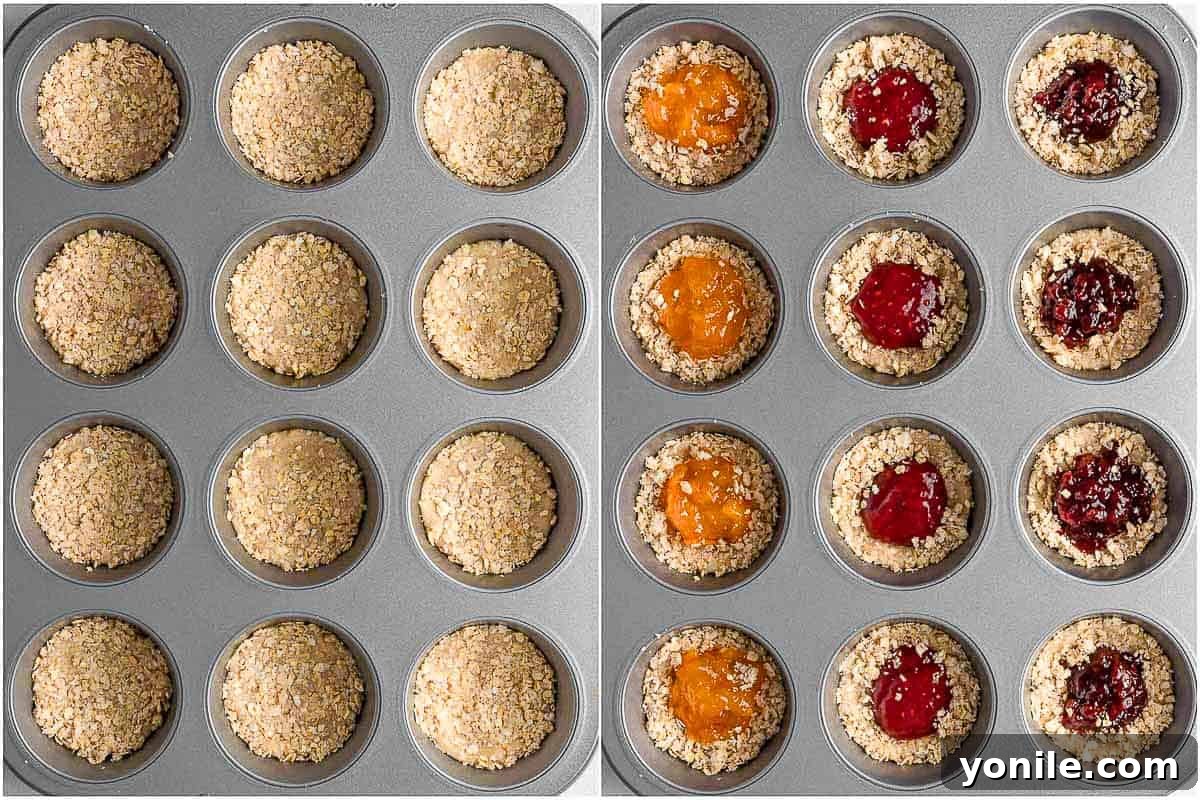 Chewy Oat Jam Treasures 5 How to fill cookies with jam, showing a spoonful of jam placed into a cookie dough divot.