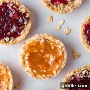 Chewy Oat Jam Treasures 10 Several oatmeal jam cookies on a tray.