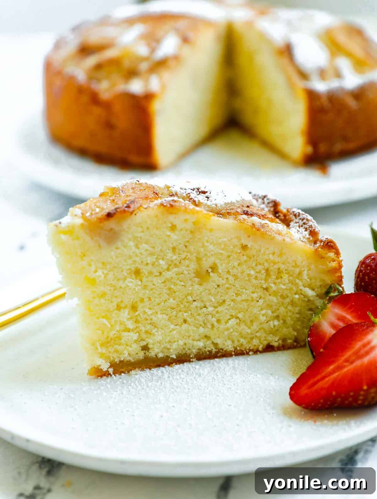 A close-up shot showing a perfectly moist slice of the easy pear cake recipe, highlighting the tender pears within.