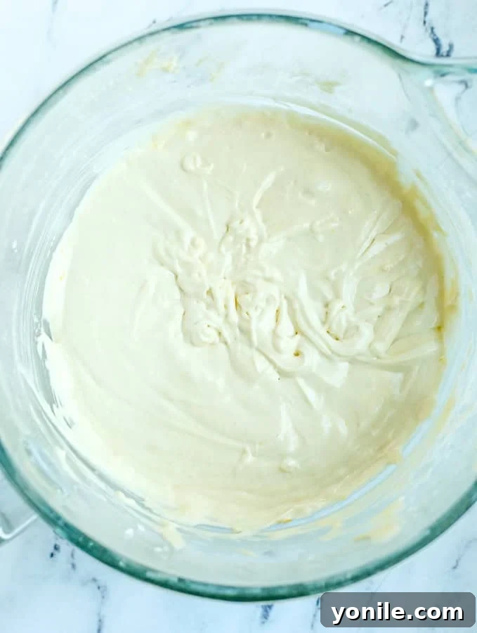 Thick pear cake batter after all ingredients have been mixed, showing a smooth consistency.