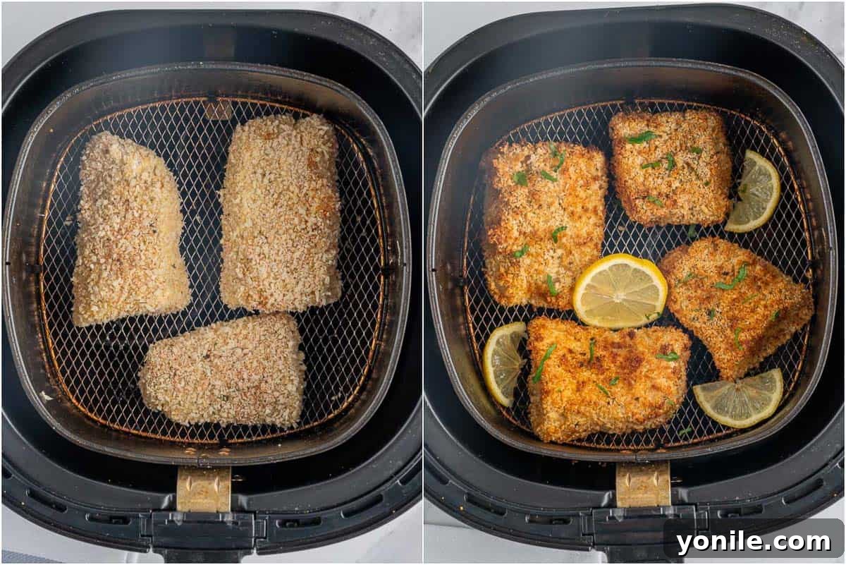 Two pieces of crispy cod cooking in an air fryer basket.