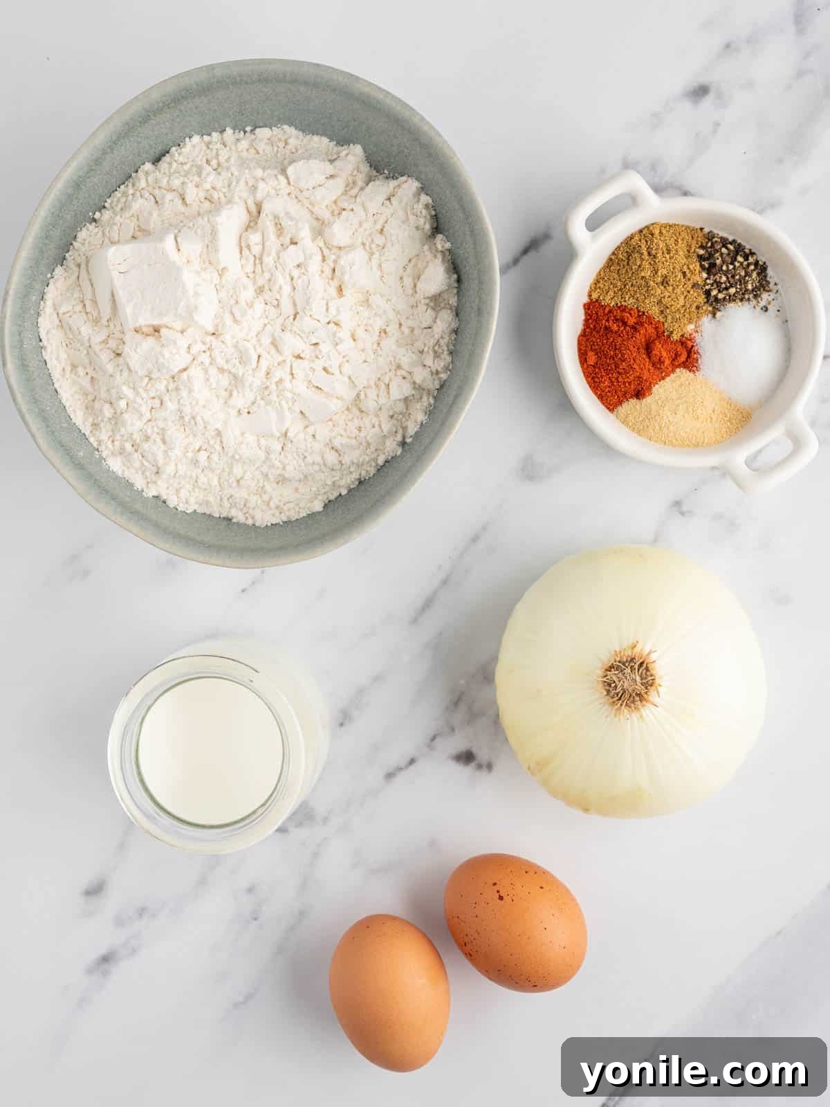 Golden Air Fryer Onion Bloom 3 Ingredients laid out for air fryer blooming onion preparation.