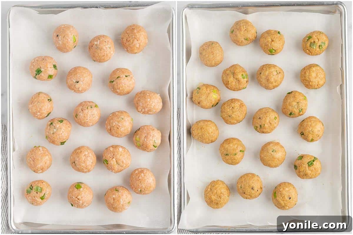 Glazed Teriyaki Chicken Meatballs 5 Baked chicken meatballs arranged on a parchment-lined baking sheet.