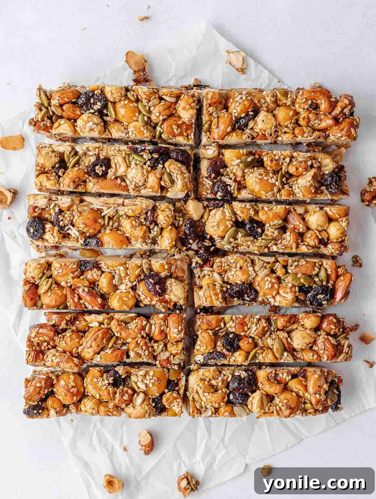 The best homemade KIND nut bars neatly cut into individual portions on parchment paper.
