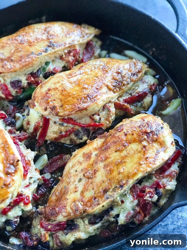 Cheesy Sundried Tomato Stuffed Chicken served beautifully in an oven-safe skillet, ready to be enjoyed.