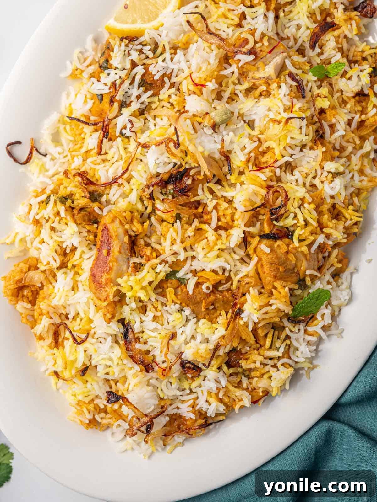 Quick Chicken Biryani 9 A large platter of fluffy, aromatic chicken biryani with tender chicken and garnishes, ready to be enjoyed.