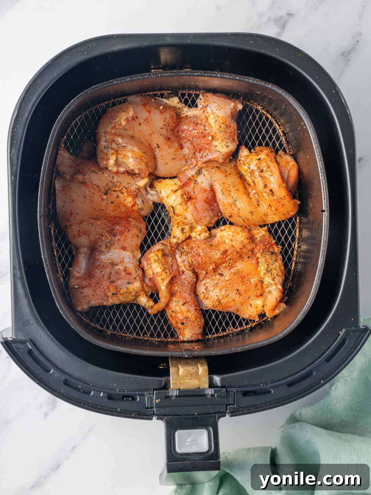 Air Fryer BBQ Chicken Perfection 5 Chicken thighs ready to be cooked in the air fryer.