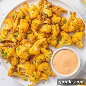 Cauliflower bites on a tray with dip.
