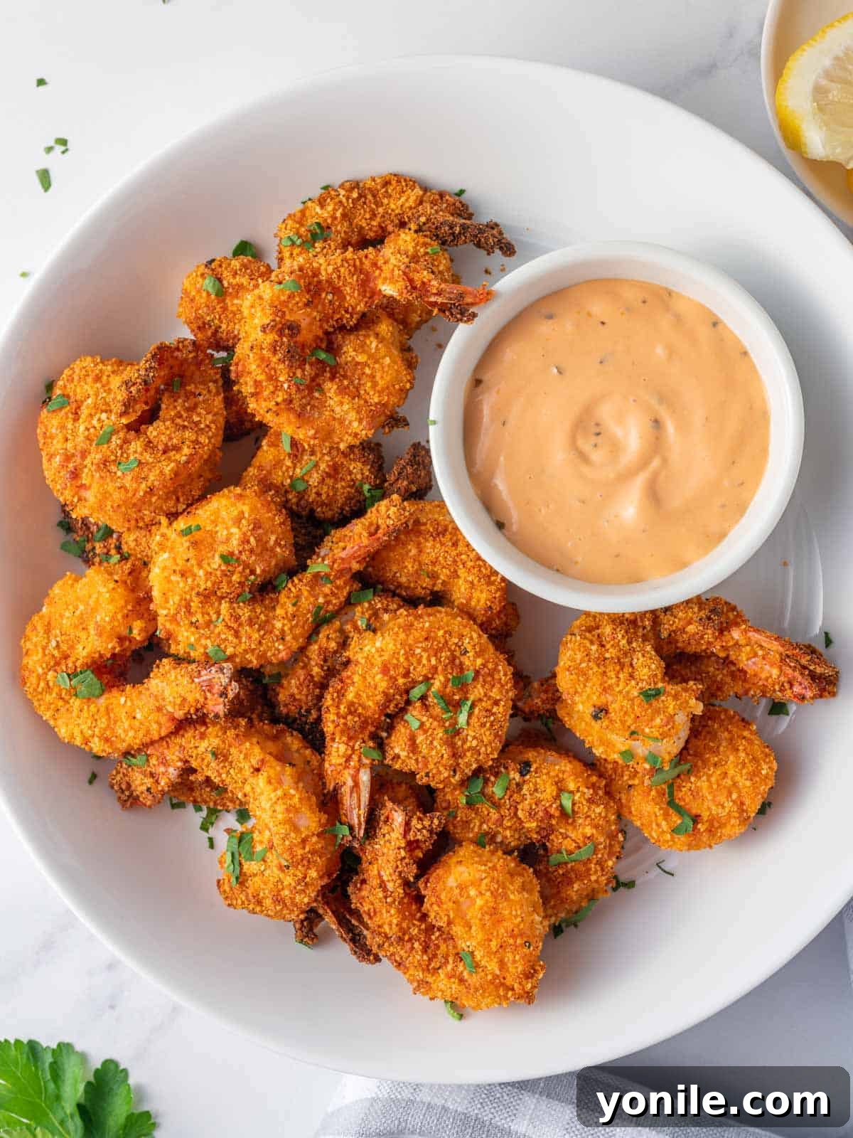 Crispy Air Fryer Keto Shrimp 6 A platter of crunchy keto breaded shrimp, ready to be served.