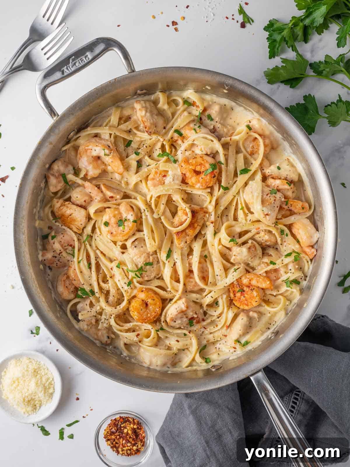 A skillet of creamy chicken and shrimp alfredo.