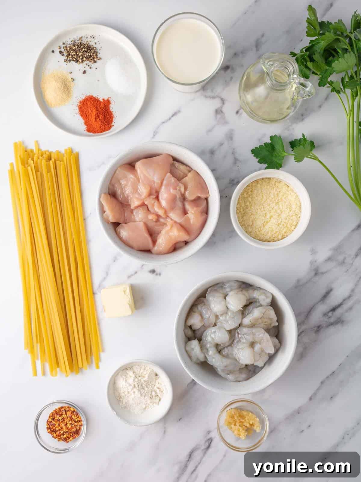 Ingredients needed for chicken and shrimp alfredo.