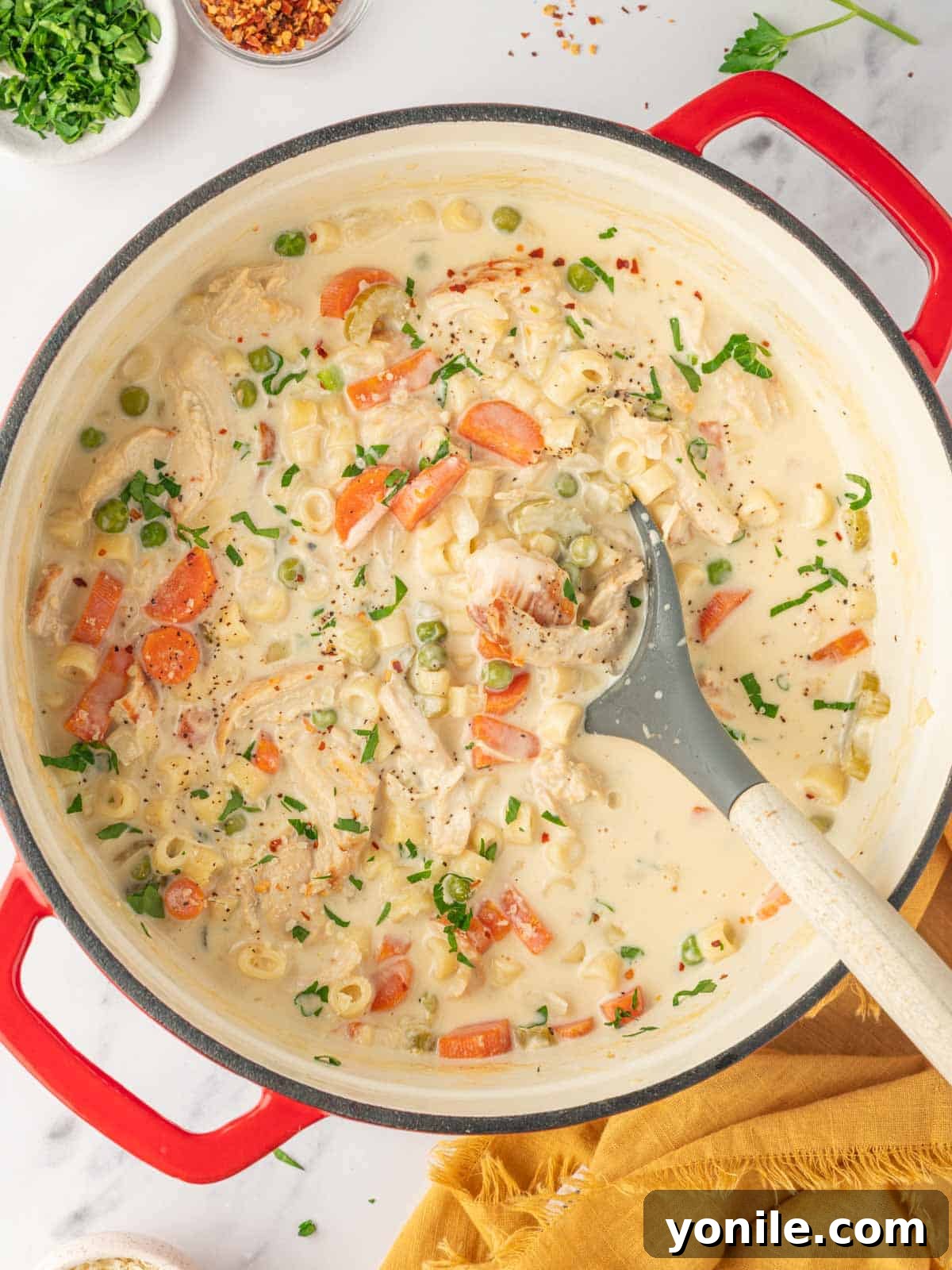 Velvety Chicken Garden Soup 7 A large pot of creamy vegetable and chicken soup, simmering.