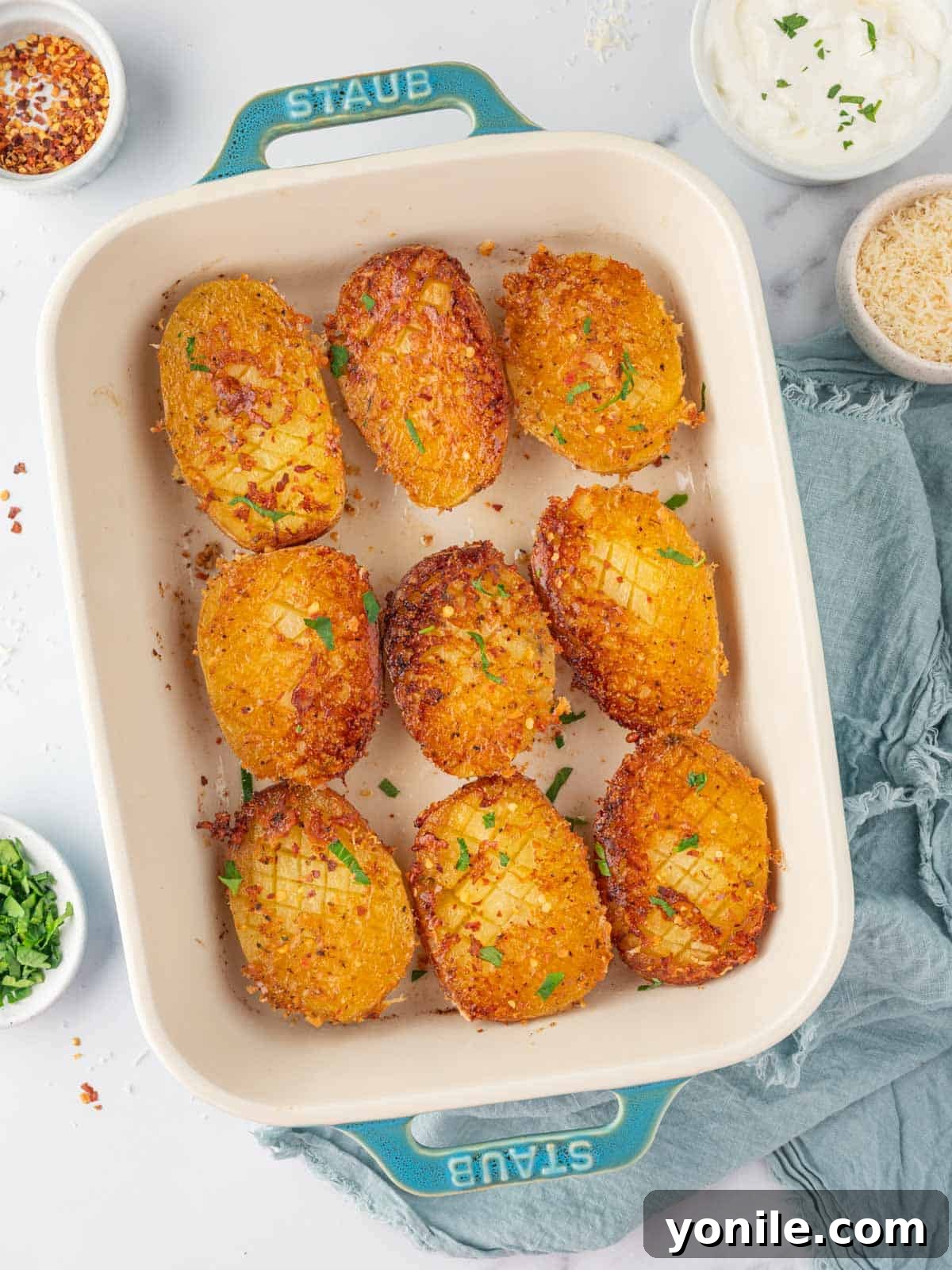 Crispy Parmesan potatoes served fresh in a baking dish, ready to be enjoyed.