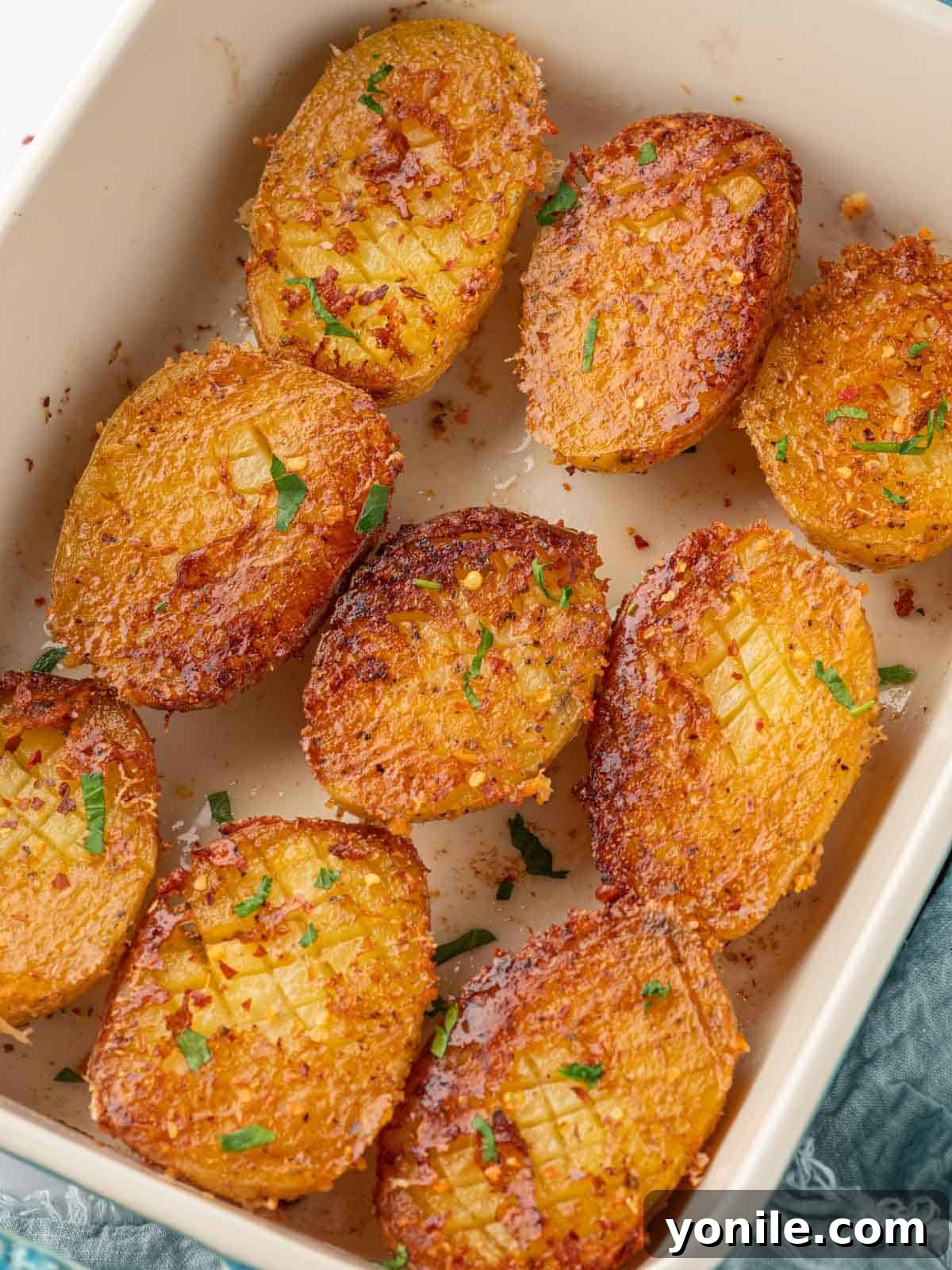 Viral Parmesan-crusted potatoes in a baking dish, perfectly golden and crispy.