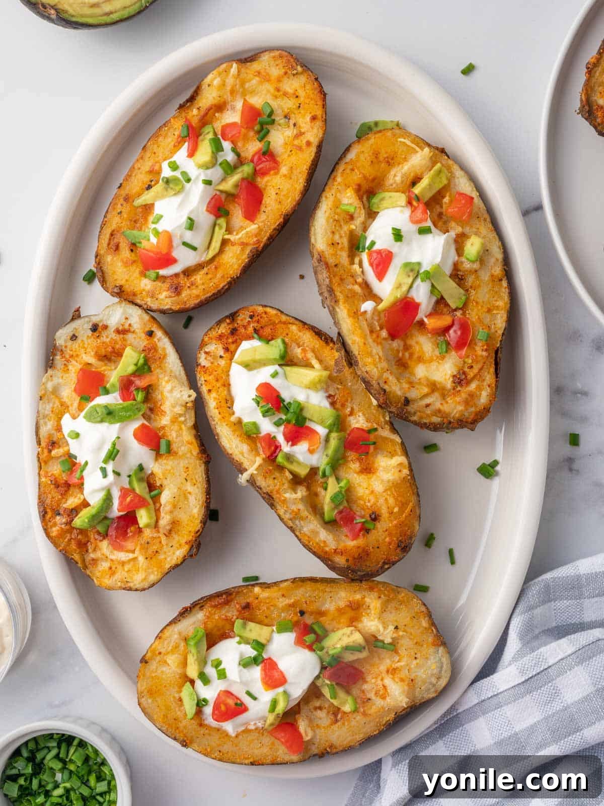 A plate of cheesy air fryer potato skins.