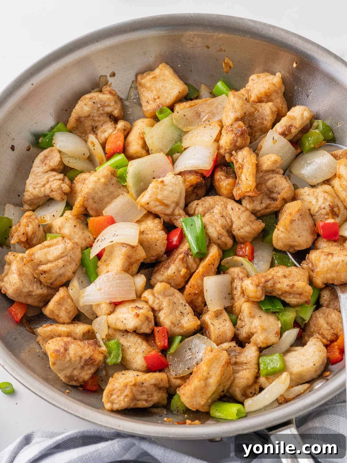 Golden Salt and Pepper Chicken 8 Crispy salt and pepper chicken in a skillet.