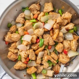 Golden Salt and Pepper Chicken 9 A spoon serves chinese chicken recipe from a wok.
