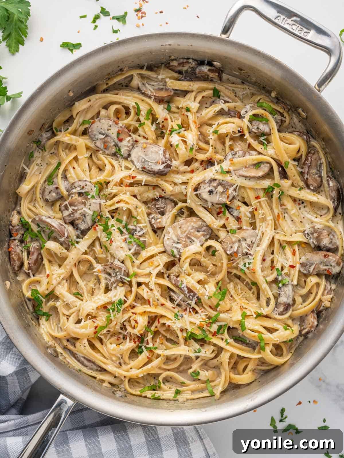 A skillet loaded with fettuccine with creamy mushroom sauce, ready to serve.