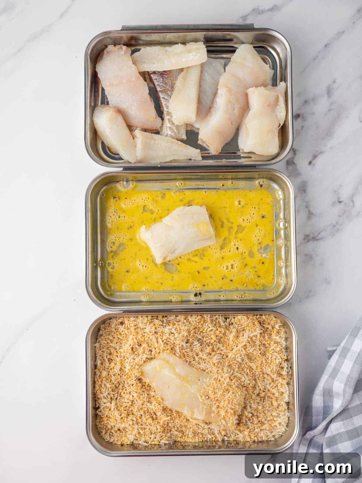 Crispy Gluten Free Fish and Chips 4 How to bread fish sticks using dredging stations, showing egg wash and panko mixture bowls.