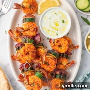 Greek shrimp kabobs with dipping sauce.
