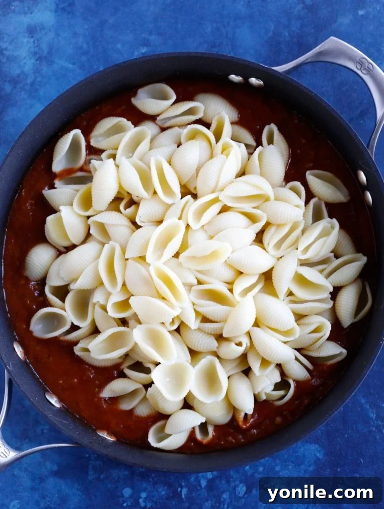 Close-up of Beef Taco Pasta simmering in a skillet, showcasing the rich sauce and cooked pasta.