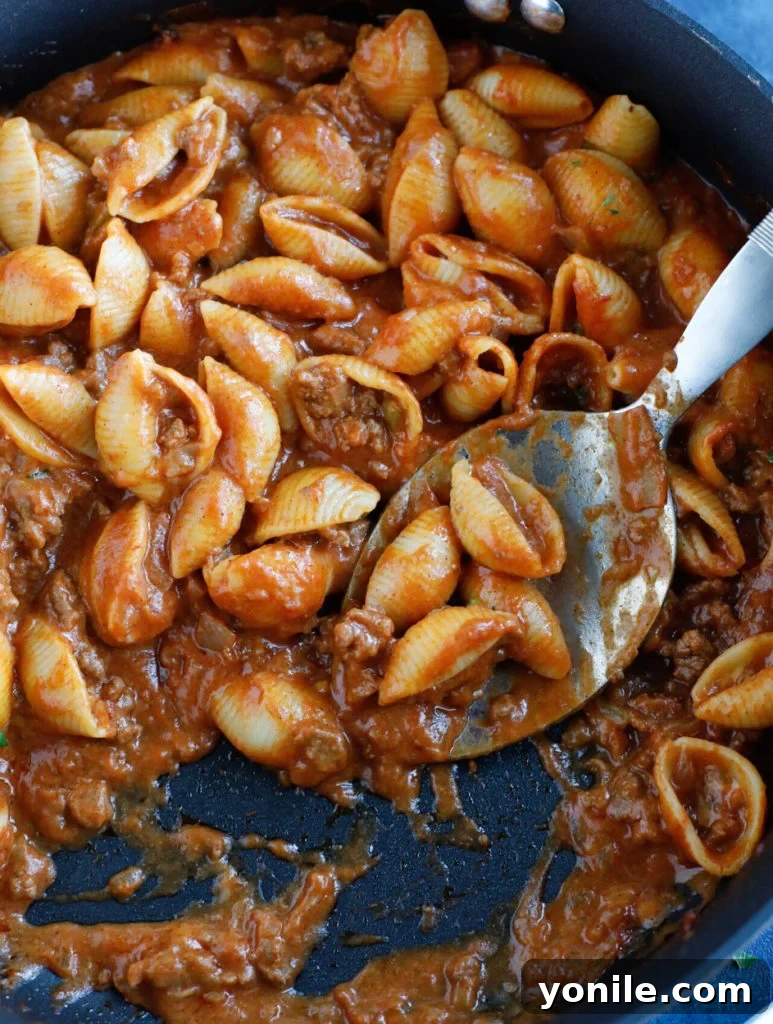 Finished Beef Taco Pasta recipe served in a pan with toppings, ready to enjoy.
