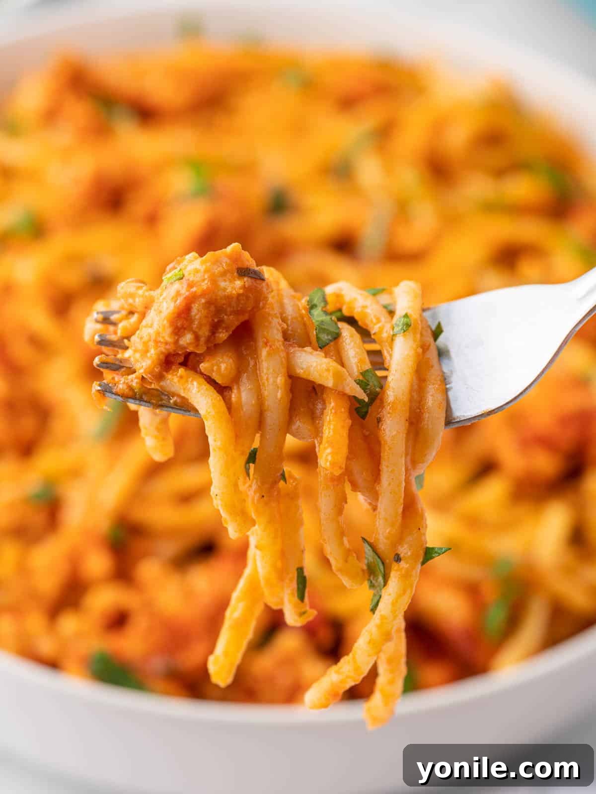 A fork picks up a bite of TikTok Spaghetti with melted cheese.