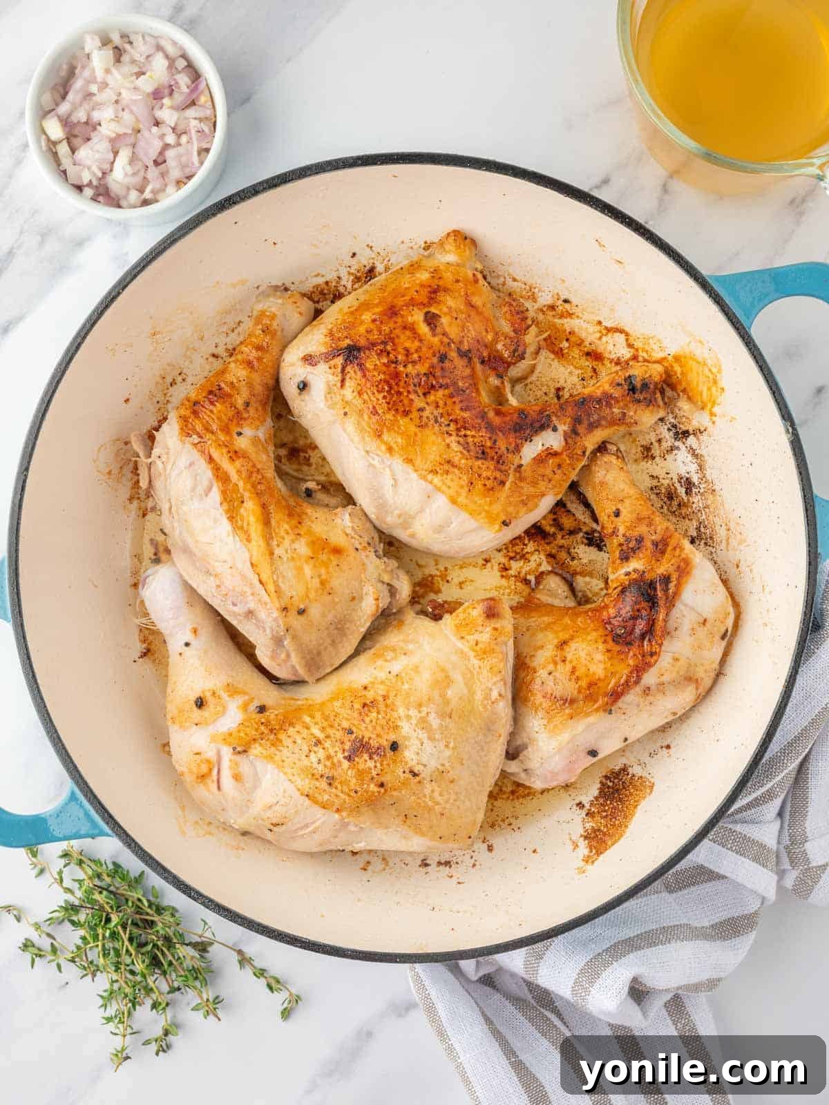 braised chicken legs in a skillet.