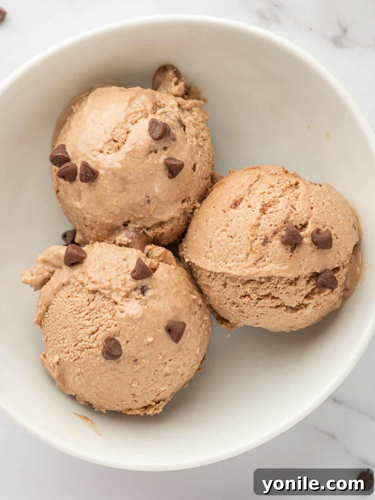 Scoops of chocolate ice cream in a bowl.