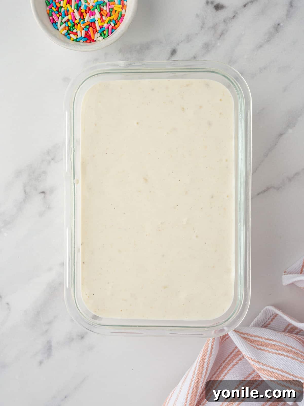Vanilla ice cream base in a freezer container.