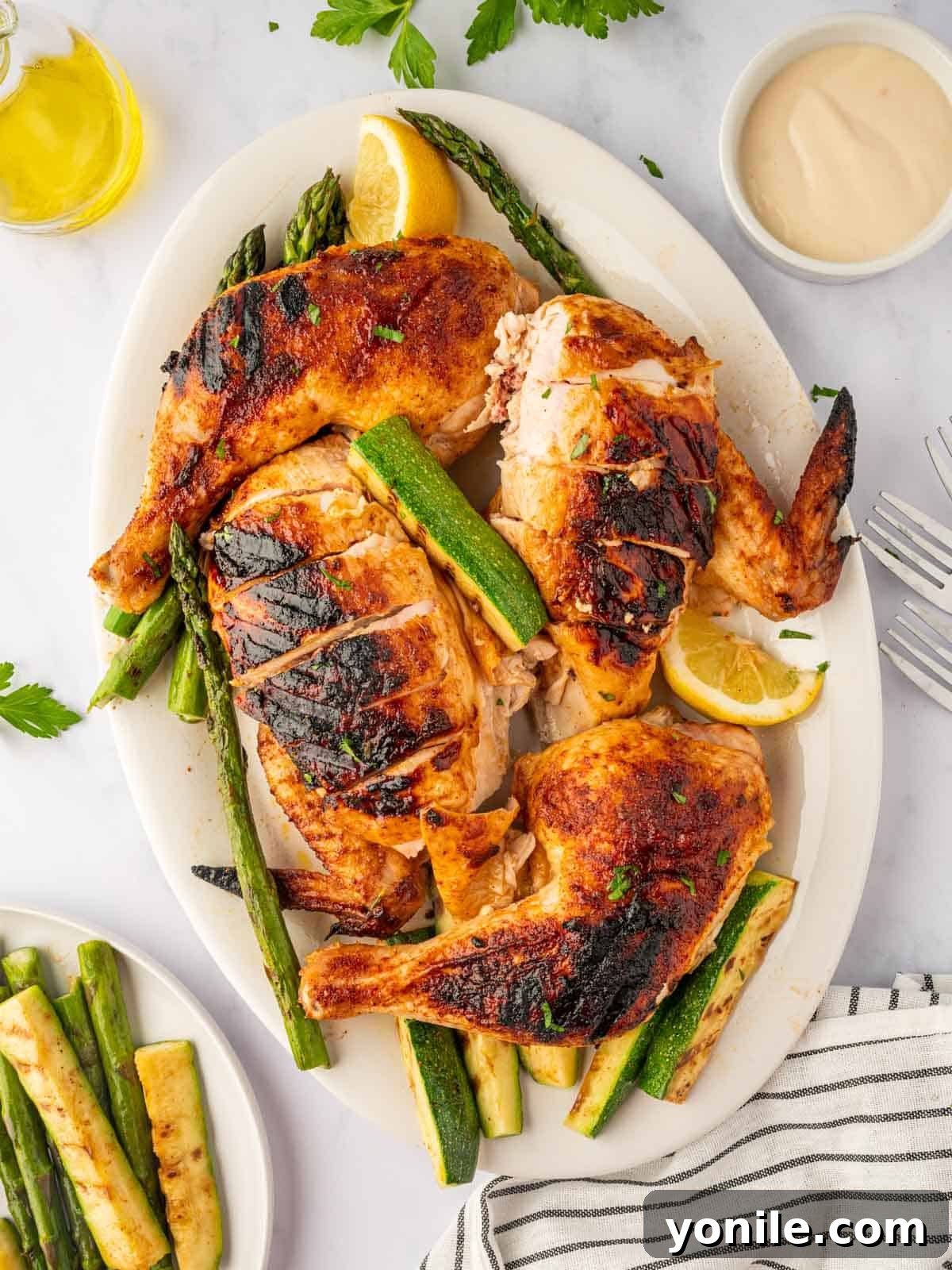 Charcoal chicken recipe is cut into pieces on a platter.