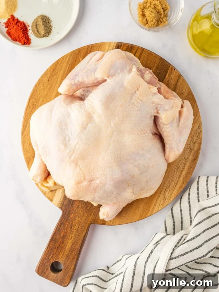 A whole chicken rests on a platter.