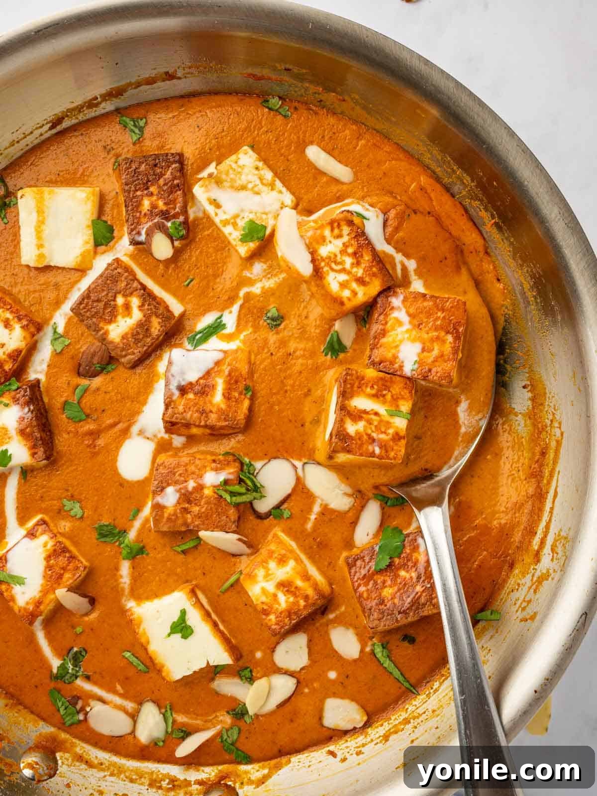 Royal Paneer Pasanda 11 A close-up shot of creamy Paneer Pasanda simmering in a skillet, showcasing its rich texture.