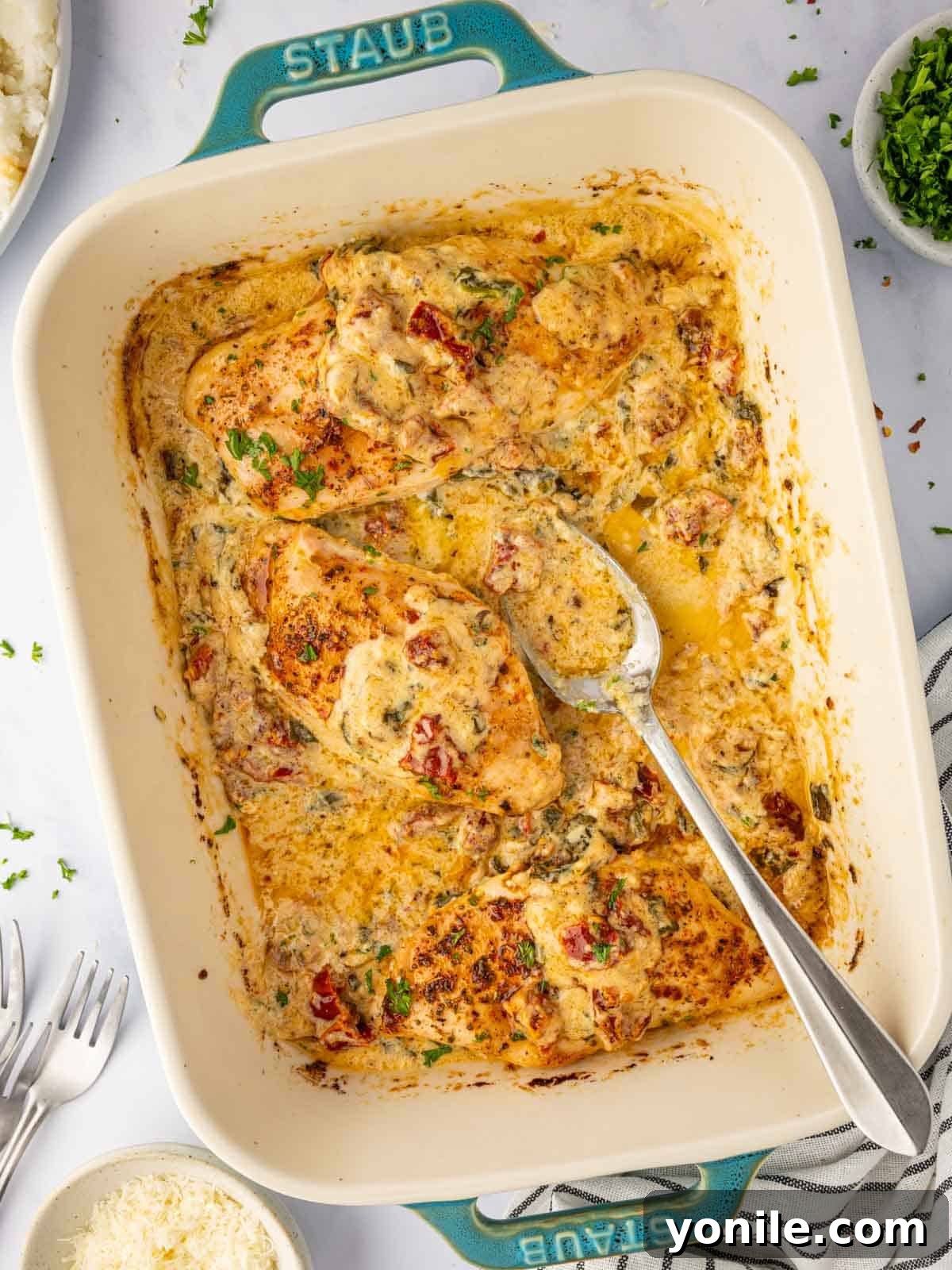 Creamy Tuscan Oven Chicken 7 Tuscan chicken casserole is being served.