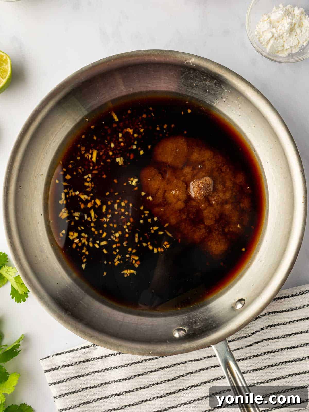 Preparing homemade teriyaki marinade in a saucepan on the stove.