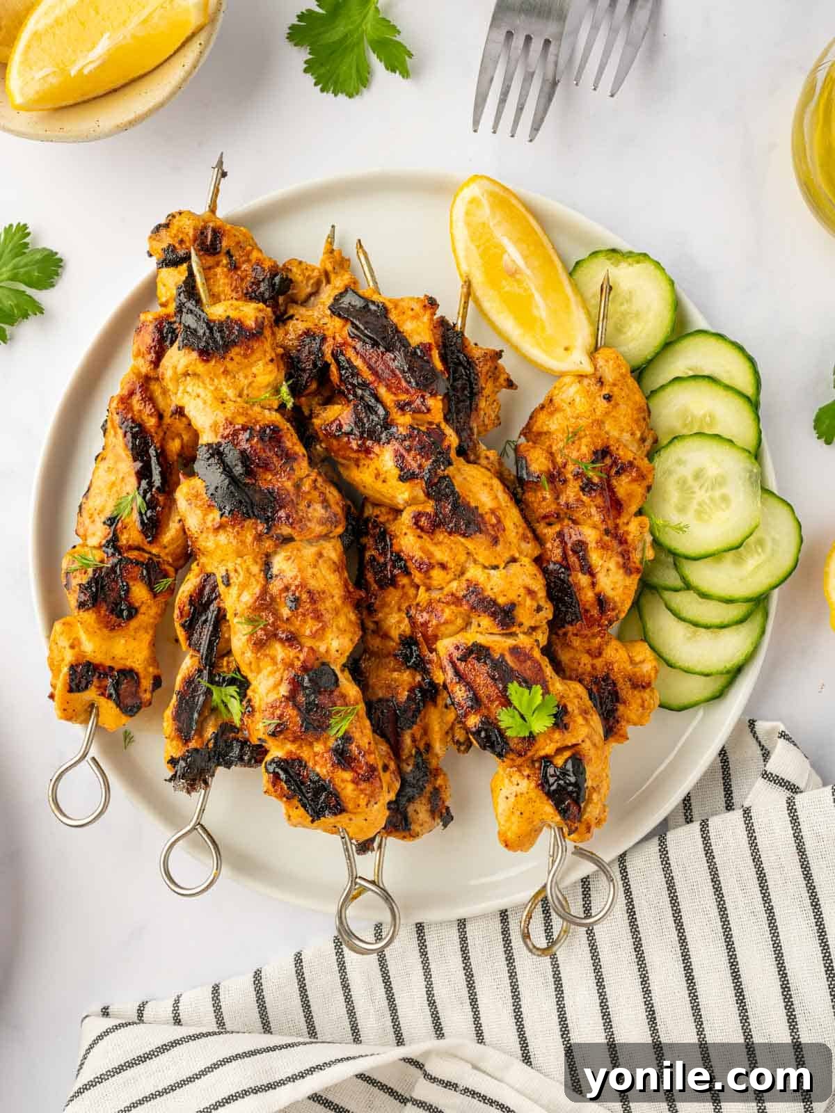 Delicious Tandoori chicken kebabs arranged artfully on a platter, ready to be served.