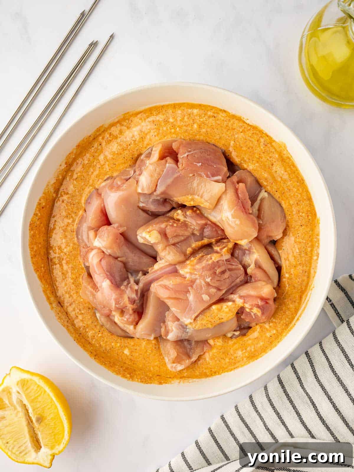 Chicken pieces generously coated in the rich Tandoori marinade, ready for infusing flavor.