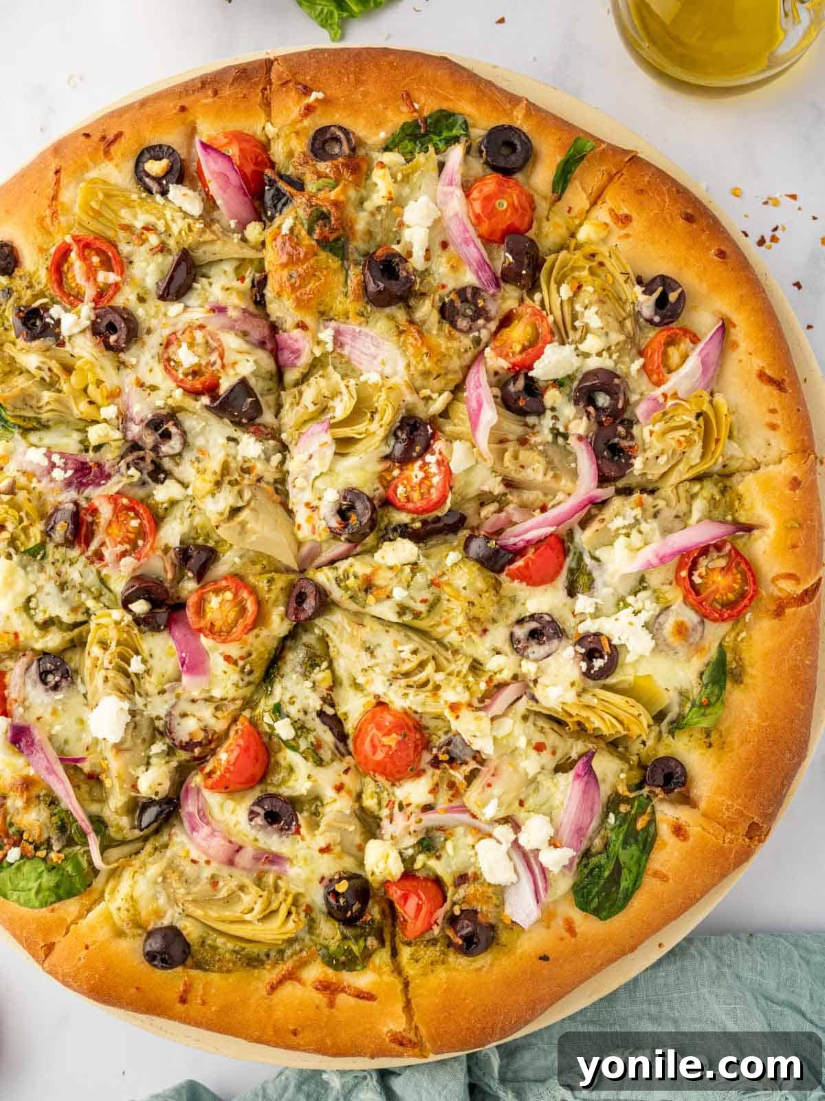 Homemade Mediterranean Pizza Feast 8 A freshly baked homemade Mediterranean pizza, cut into eight perfect slices, showcasing the delicious toppings.