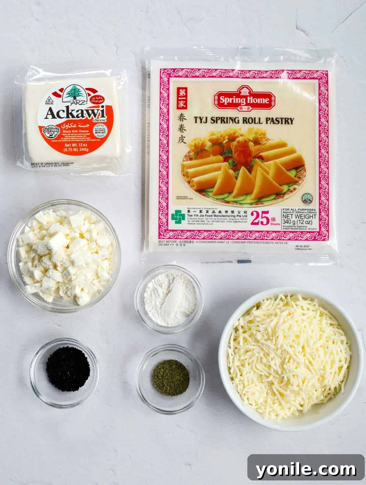 Crispy Cheese Rolls 3 A curated selection of fresh, high-quality ingredients laid out for making Lebanese Cheese Rolls, including various cheeses, dried herbs, and nigella seeds.