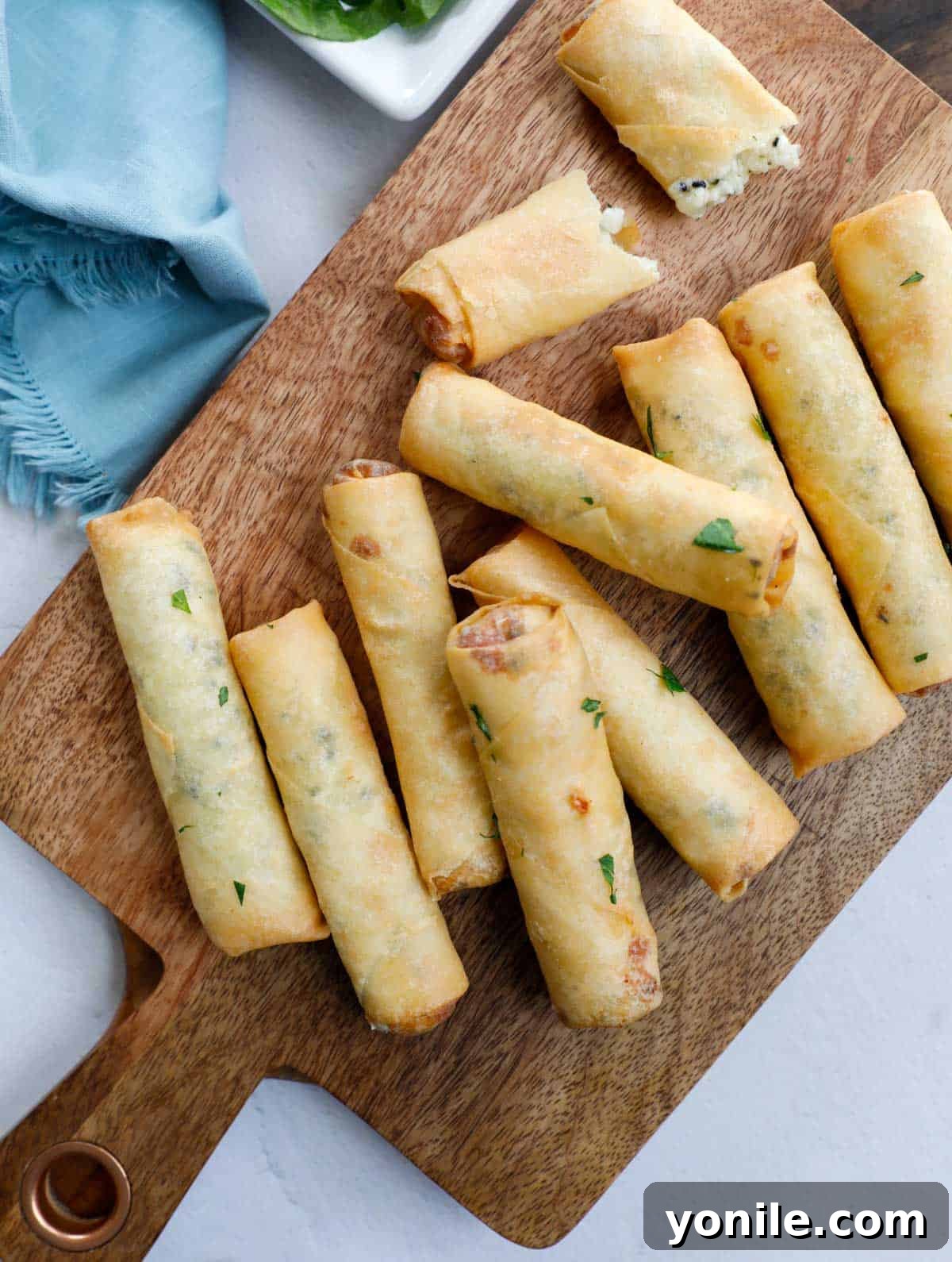 Crispy Cheese Rolls 9 A close-up shot of several golden-brown Lebanese Cheese Rolls, perfectly fried and stacked, ready to be enjoyed as a savory Middle Eastern appetizer.