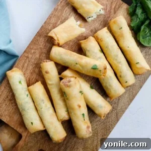 Crispy Cheese Rolls 10 Fried Lebanese Cheese Rolls on a wooden board.