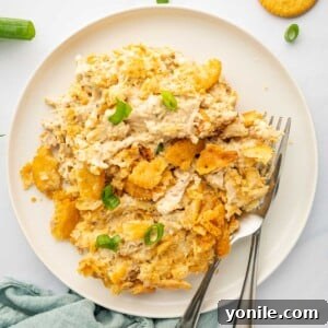 Decadent Chicken Bake 9 A portion of million dollar chicken is on a plate with 2 forks.