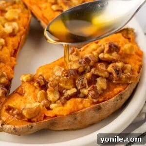 A drizzle of maple syrup is added to sweet potatoes.