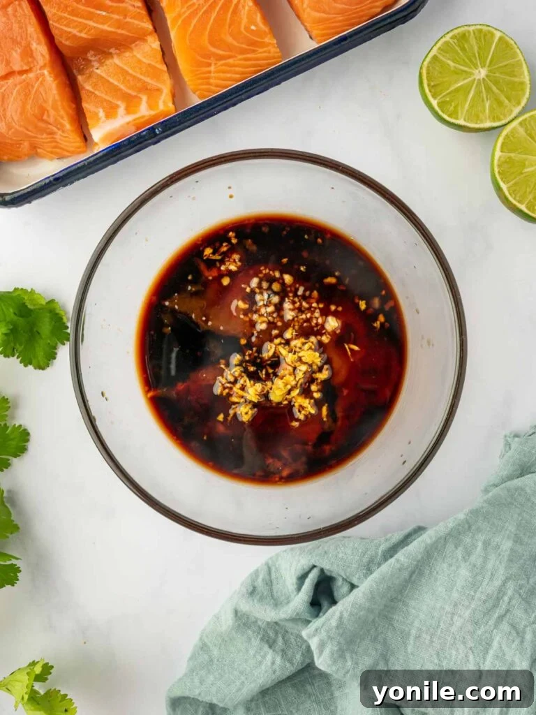 Thai Chili-Lime Baked Salmon 5 A vibrant, rich Thai salmon marinade being vigorously mixed in a bowl, showcasing its depth of color and smooth consistency.