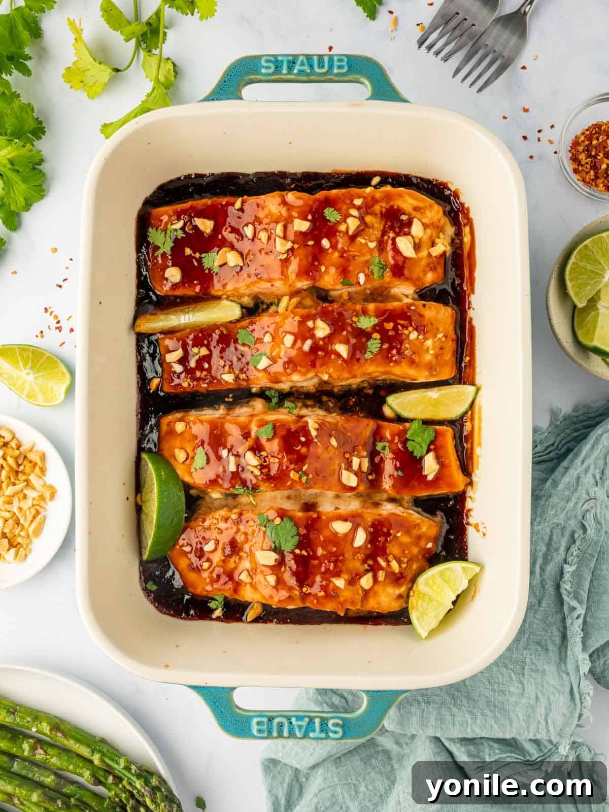 Thai Chili-Lime Baked Salmon 7 Beautifully baked Thai salmon in a baking dish, golden brown and garnished with fresh herbs, ready to be enjoyed.